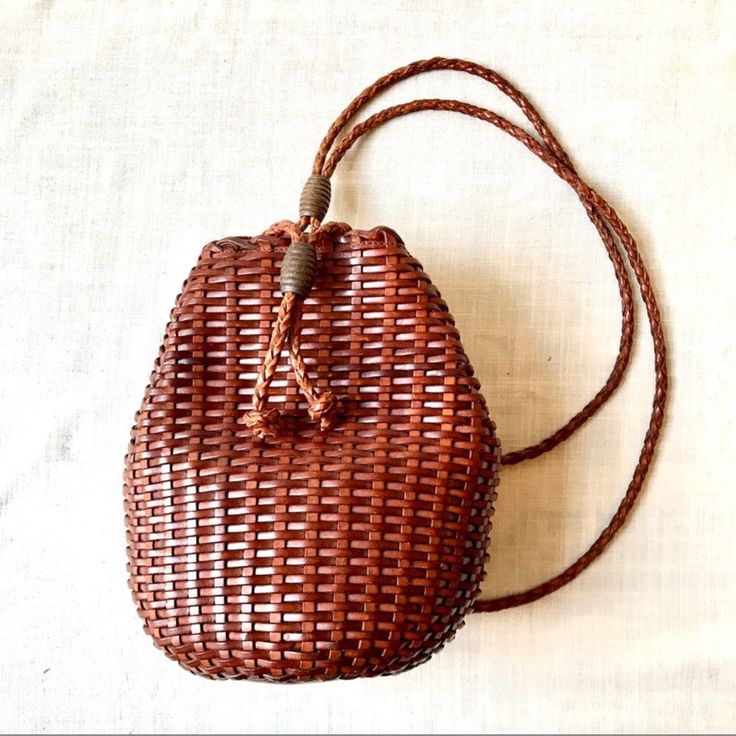 Vintage Italian Chestnut Colored Woven Leather Basket Style Mini Backpack, With Round Braided Leather Straps, Adjusted With Carved Wooden Beads, Drawstring Style Top Opening. Thick Solid Leather Bottom. Fully Lined With Zippered Interior Pocket. 11" Tall, 11" Wide, Straps Roughly 33" Long. In Excellent Vintage Condition, No Brand Name. Leather Basket, Basket Style, Chestnut Color, Braided Leather, Mini Backpack, Vintage Italian, Wide Straps, No Brand, Wooden Beads