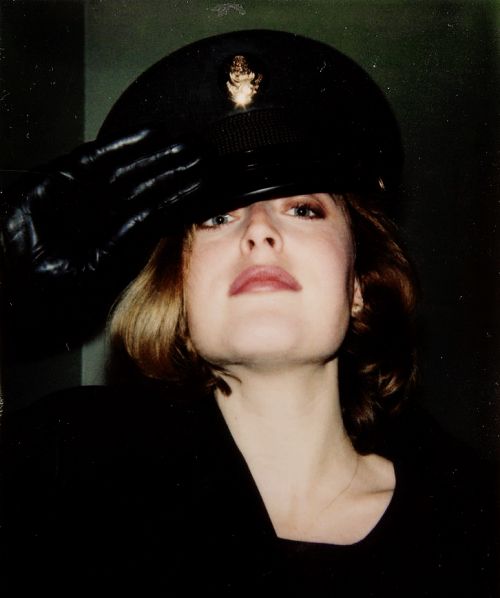 a woman wearing a black hat and gloves