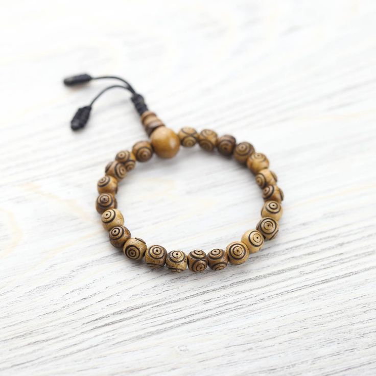 Handcrafted in Nepal, this wrist mala bracelet combines two of our favorite spiritual values - protection and impermanence. Each traditional bone bead is carved with the Evil Eye symbol for protection. They serve as a reminder to live in the present moment; because nothing is permanent, everything is possible. Because the beads are naturally stained, the color can begin to fade over time and with use. We consider this special process to be a visual representation of the growth in your practice a Symbol For Protection, Evil Eye Symbol, Nothing Is Permanent, Buddhist Practices, Spiritual Values, Wrist Mala, Eye Symbol, Nothing Lasts Forever, Adjustable Knot