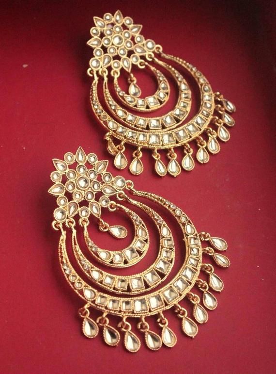 Shine like a glowing star in these  high quality brass and kundan earrings  .Pair them up with your silks and satins and  add charm and charisma to your beautiful personality. Earrings length 3.2 inchesWidth 2 inchesWeight 42 gmsKeep your precious Kundan jewelry away from perfume,spray and water.Keep it away from direct heat, water, perfumes, deodorants and other strong chemicals as they may react with the metal or plating.The plating composition of Jewellery is as such that perspiration (sweat) Wedding Bollywood Style Brass Chandbalis, Wedding Bollywood Style Chandbalis In Brass, Wedding Bollywood Chandbalis In Brass, Wedding Diwali Brass Chandbalis, Wedding Brass Chandbalis For Diwali, Festival Brass Earrings With Cutdana, Brass Danglers For Wedding And Festivals, Brass Bridal Earrings For Festivals And Celebrations, Heavy Brass Chandbali Earrings