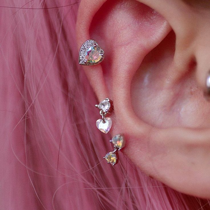 a close up of a person's ear with some piercings on it