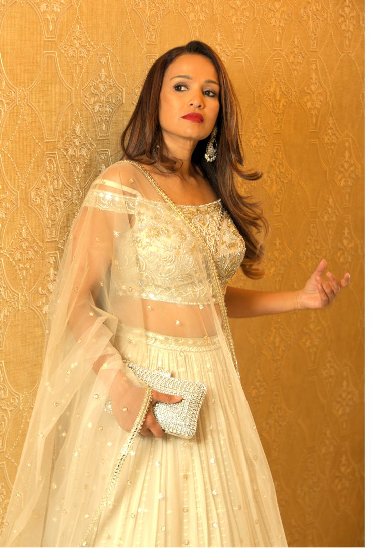 Indulge in the opulent allure of this enchanting lehenga, adorned with exquisite mirrors, lustrous pearls, and intricate embroidery, designed to enhance your natural elegance and elevate your style with a touch of grandeur. Experience the luxurious beauty of Radhika Lehenga, crafted with stunning mirrors, shimmering pearls, and intricate detailing that reflects sophistication and enhances your natural grace. Embrace the grandeur of this premium product and elevate your sense of style. Color - Pe Elegant Festive Pre-draped Saree With Intricate Embroidery, Glamorous Pearl Embroidery Sets For Reception, Glamorous Designer Sharara With Pearl Embroidery, Glamorous Traditional Drape Sets With Dupatta, Elegant Designer Lehenga With Pearl Embroidery, Designer Pearl Embroidered Elegant Lehenga, Elegant Organza Lehenga With Pearl Embroidery, Glamorous Organza Sharara With Mirror Work, Designer Pearl Embroidery Lehenga