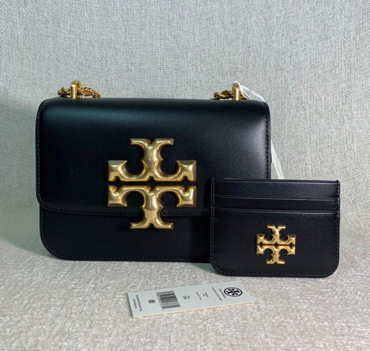 You Are Looking At A Very Adorable Black Leather Eleanor Small Convertible Shoulder Bag/Cross Body Bag + Eleanor Card Case Set By Tory Burch FAST SHIPPING !! ARRIVES IN 2-3 BUSINESS DAYS. AUTHENTIC GUARANTEED BY MONEY BACK. FEEL FREE TO VERIFY AUTHENTICTY AT ANY TORY BURCH LOCATION. Please see all 12 pictures and read the entire description before placing your order. Visit my store for a wide selection of beautiful leather bags CLICK HERE -----> Visit My eBay Store MonarcoMonarco 100% Authentic Tory Burch Guaranteed !!!! Retail: $648.00 + $128.00 = $776.00 Eleanor Small Convertible Shoulder Bag/Cross Body Bag by Tory Burch. This bag is made of black genuine smooth leather. This bag is convertible. Can be carried as a shoulder bag or cross body bag. Dimensions: 7.5" wide across bottom x 5.4 Tory Burch Small Bag, Tory Burch Bag, Cross Body Bag, Leather Interior, Small Bags, Body Bag, Card Case, Smooth Leather, Cross Body