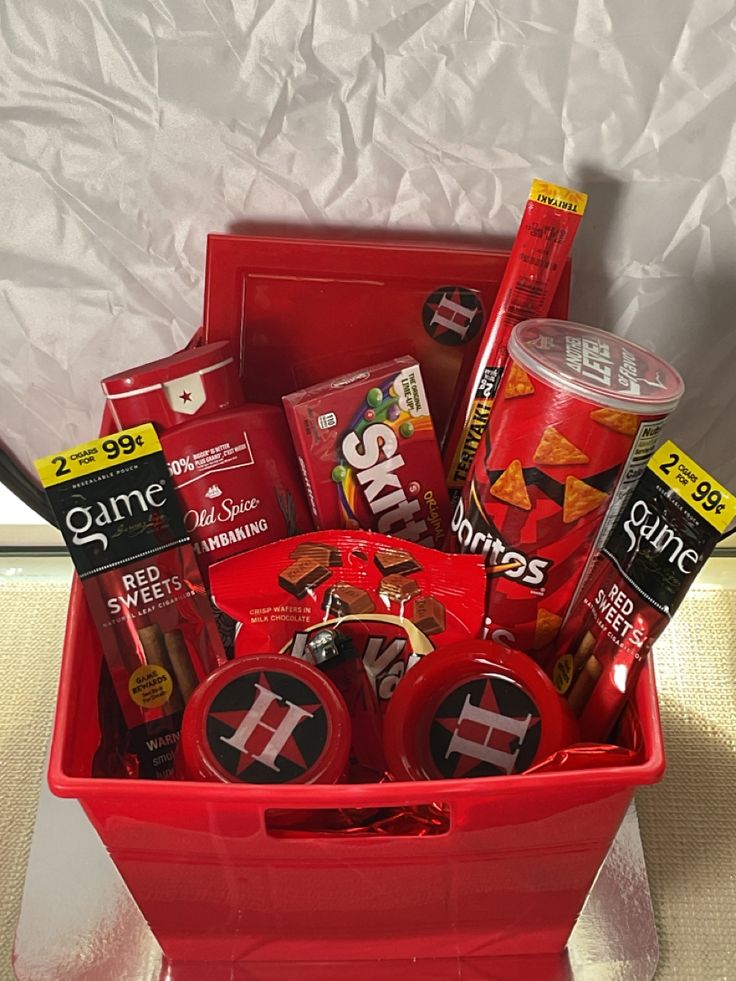 a red container filled with assorted items on top of a table