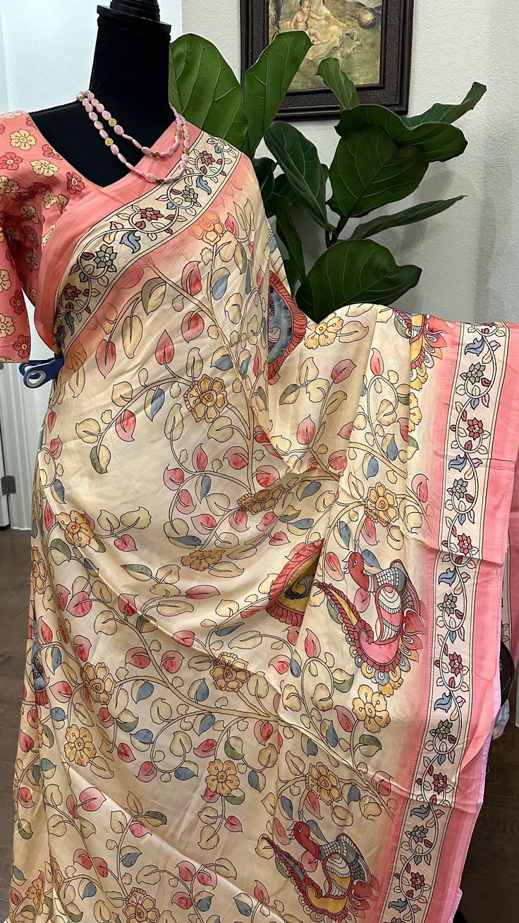 Satin crepe pure gajji  silk saree with prestitched blouse Kalamkari prints.. blouse -36 goes up to 42 inches   With embroidered gotta borders.   DETAILS AND CARE Color : satin crepe gajji silk printed sarees  Weight : 600 - 800 grams Length : 5.5 m saree + 0.7 m blouse  Width : 48 Inches Fabric :satin  Craft Description :  Wash Care : Dry Wash Only Shipping Time : 5 - 7 Working days We Ship Worldwide SHIPPING AND RETURNS Shipping Policy : Shipping days as mentioned above, subject to changes based on the government regulations around the prevailing pandemic situation.  Return Policy :   We have a comprehensive returns policy , kindly refer to our policy section to know more . DISCLAIMER Colour : There can be a slight variance in the colours of the products on our site from the actual ones. Bohemian Silk Pre-draped Saree For Puja, Pink Bohemian Pre-draped Saree For Festivals, Bohemian Pre-draped Saree With Printed Motifs For Festivals, Festival Art Silk Pre-draped Saree With Printed Motifs, Silk Pre-draped Saree With Block Print, Art Silk Saree With Kalamkari Print, Art Silk Saree With Kalamkari Print In Traditional Drape, Pink Block Print Saree For Navratri, Raw Silk Saree With Printed Border