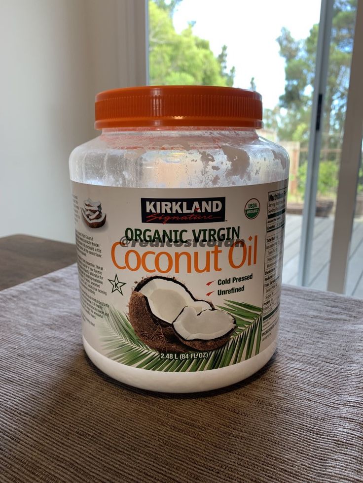 a jar of organic virgin coconut oil sitting on a table