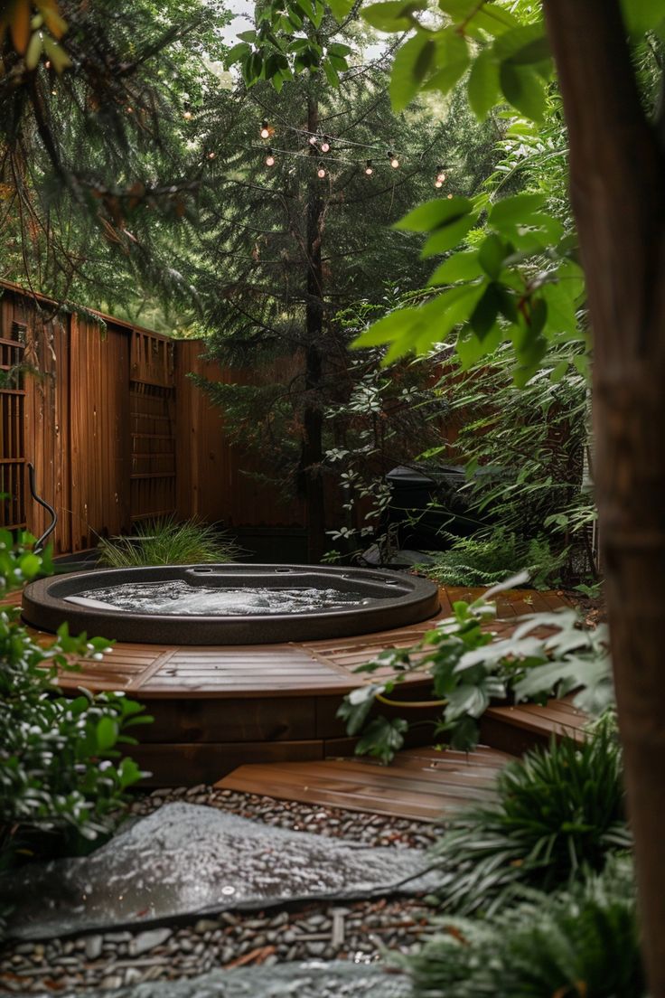 an outdoor hot tub surrounded by trees and plants