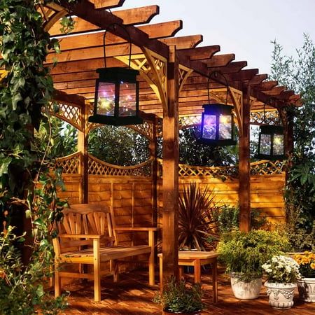 a wooden gazebo with benches and potted plants