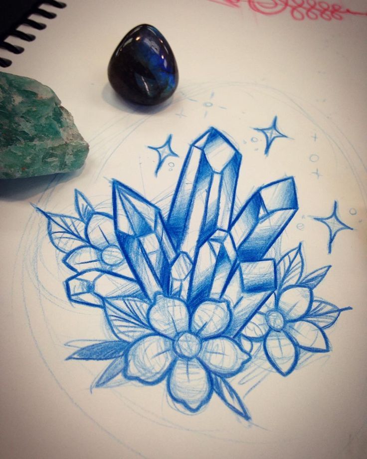 a drawing on paper with a rock next to it