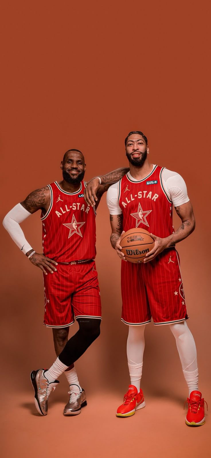 two basketball players are posing for a photo