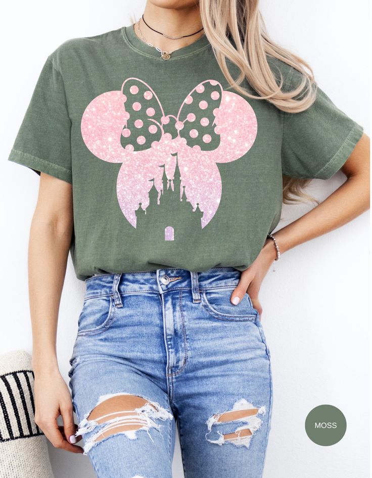 This Minnie-shaped tee is a delightful blend of charm and whimsy, featuring a vibrant pink bow adorned with daisies. Step into the world of Daisy Dreams with this adorable shirt, perfect for adding a touch of Disney magic to your wardrobe. Made from soft, comfortable cotton, it's an ideal choice for both casual outings and Disney-themed adventures. Flaunt your love for Minnie Mouse and daisies with this eye-catching tee from Oopsie Daisy! Casual Short Sleeve T-shirt With Pink Bow, Cute Minnie Mouse T-shirt For Summer, Disney Minnie Mouse Pink T-shirt, Fun Pink Minnie Mouse Top, Cute Pink Minnie Mouse T-shirt, Disney Pink Minnie Mouse T-shirt, Pink Disney Cotton T-shirt, Summer Minnie Mouse Short Sleeve T-shirt, Green Disney Cotton T-shirt