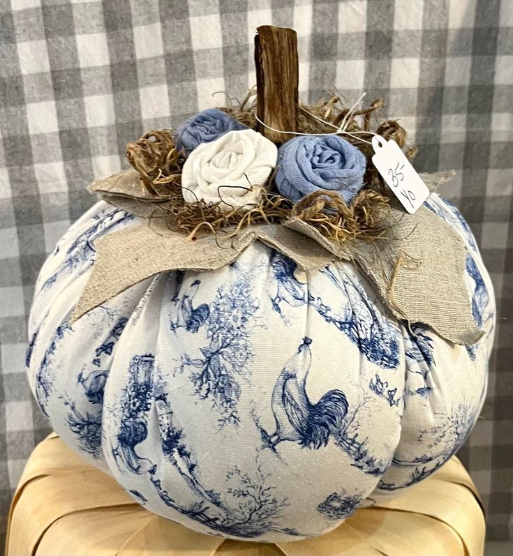 a blue and white pumpkin sitting on top of a chair