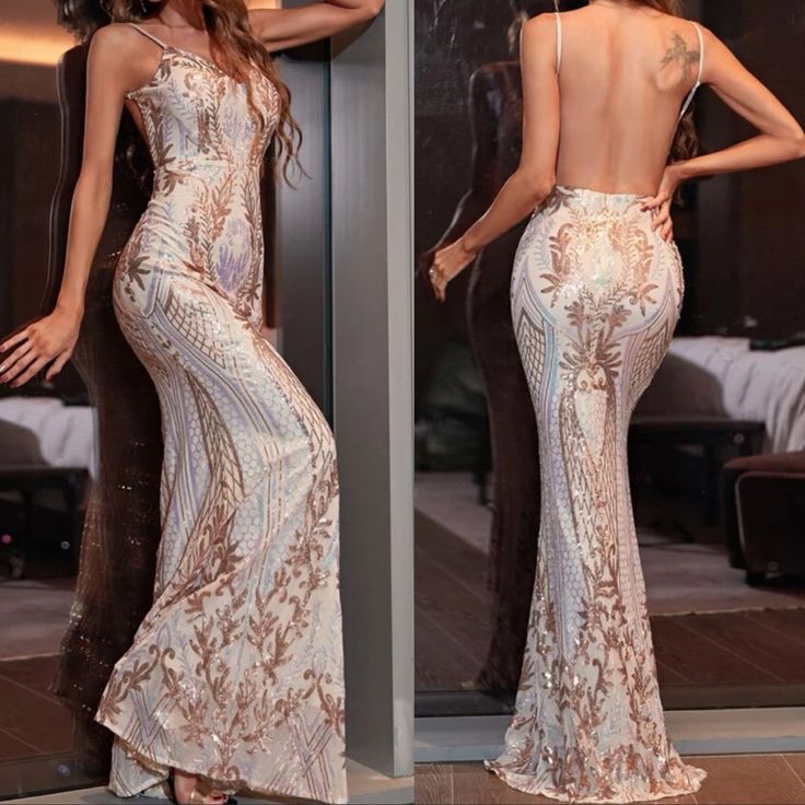 a beautiful woman in a long dress standing next to a mirror with her back turned