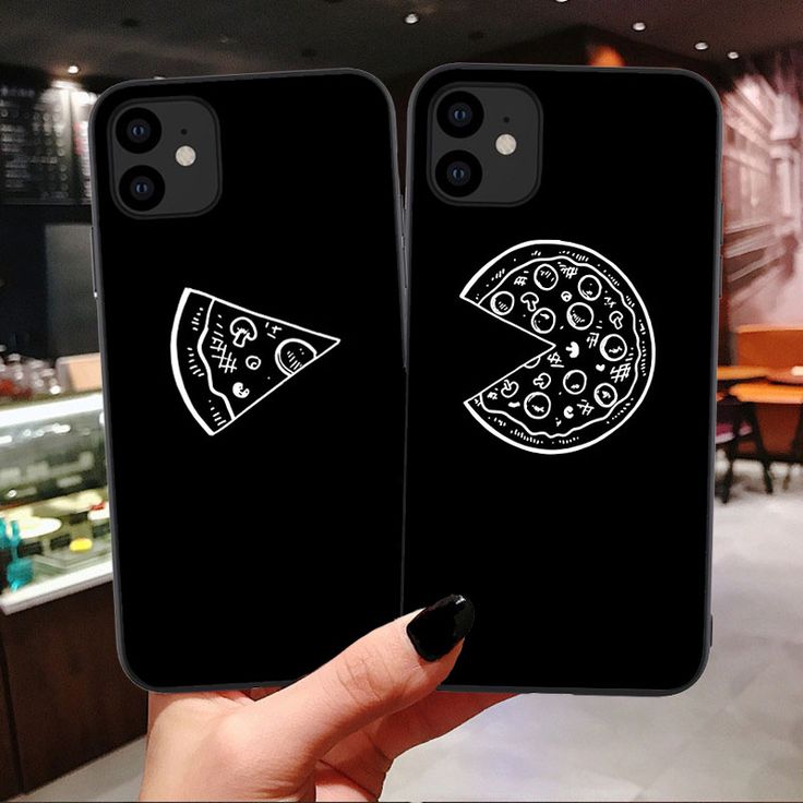 two black phone cases with pizza slices on them in front of a restaurant counter top