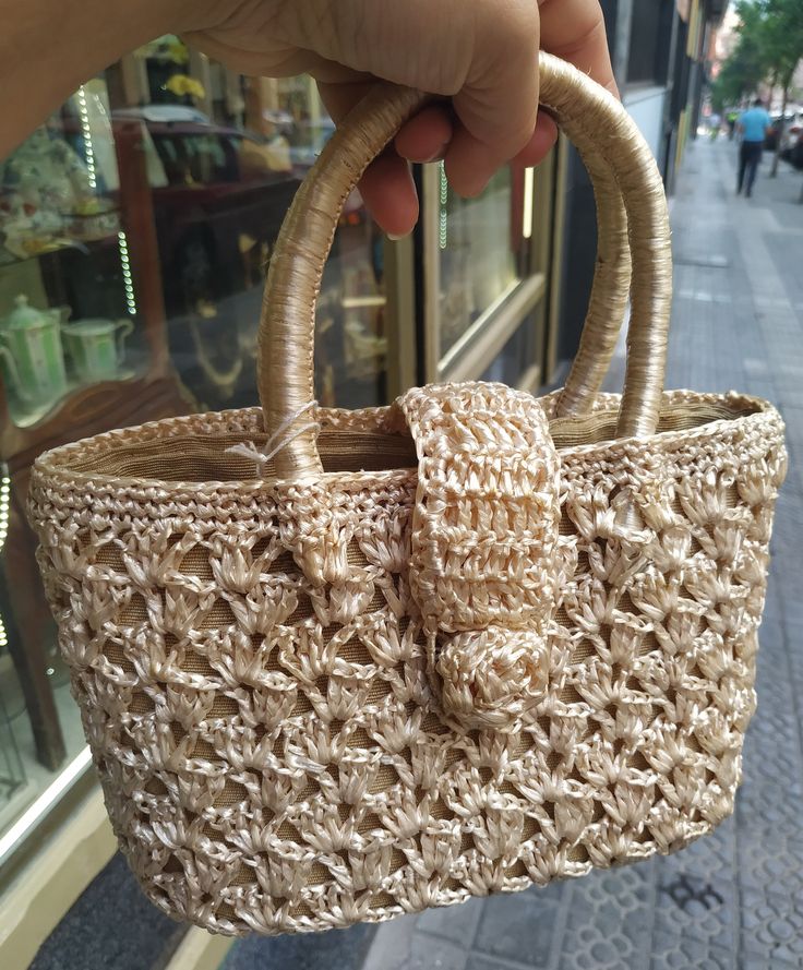 "Welcome! A beautiful vintage beige raffia handbag In good vintage condition! Measures: W: 9.24\" (24 cm) H with handles: 9.24\" (24 cm) Deep: 3.5\" (8 cm) Thanks for stopping by!!IMPORTANT: Due to the delicate situation We're all going through, and in order to keep the safety of courier workers too, all orders will be dispatched when alert sanitary finished. You can purchased or reserve items like always. Thanks so much for your understanding." Elegant Beige Straw Bag With Top Carry Handle, Elegant Straw Bags With Rolled Handles, Elegant Basket Straw Bag With Rolled Handles, Beige Basket Shoulder Bag With Top Carry Handle, Elegant Natural Straw Bag With Top Carry Handle, Beige Straw Shopping Bag With Rolled Handles, Beige Bucket Crochet Bag With Handles, Beige Basket Bag With Top Carry Handle, Elegant Beige Crochet Bag With Top Carry Handle