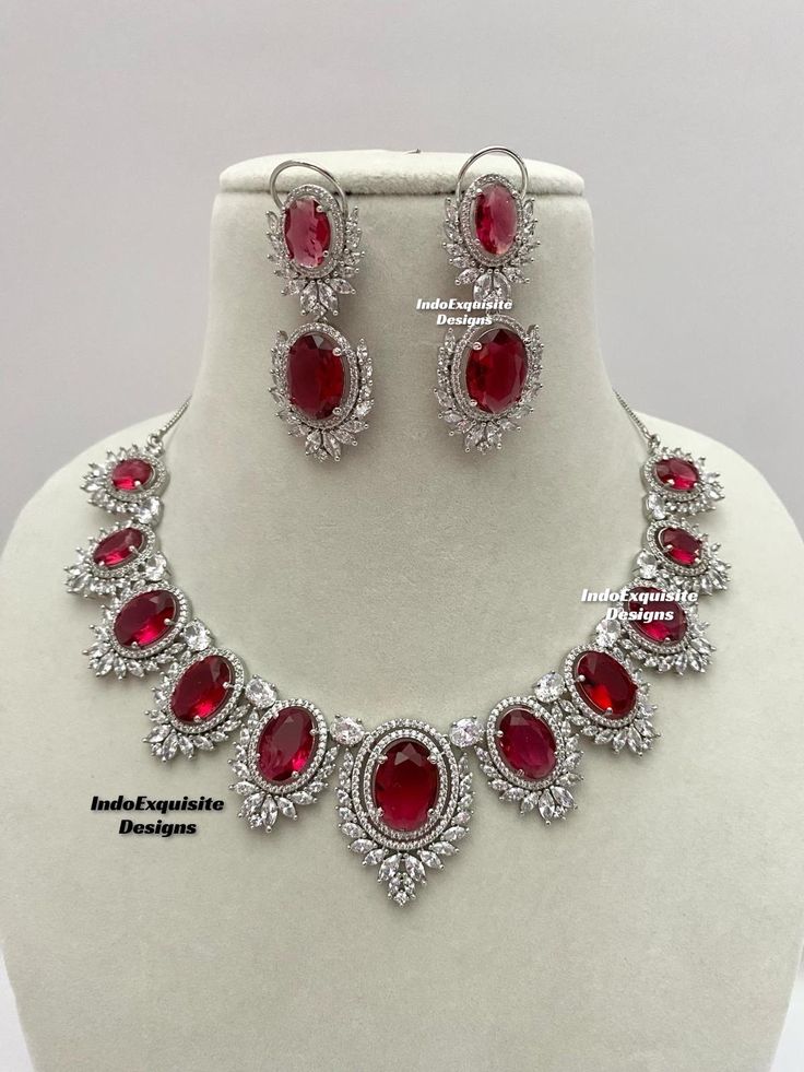 American Diamond Necklace Set / CZ Necklace/Indian Jewelry/ Reception Jewelry/ Bollywood Jewelry/ Silver Red  All items are shipped from Brampton, Ontario, Canada. If you need your item by a certain day, please reach out to us for express delivery option before placing the order so that we can update the shipping for you. Standard shipping/delivery timeline Below are the delivery timeline estimates. We dispatch all orders by the next business day. ---> USA delivery timeline * 3-6 business days to major urban centers in USA. It may take days extra to remote locations ---> Canada delivery timeline  * 2-3 business days - GTA  & Montreal  * 2-4  business days - Rest of Ontario/Quebec * 3-6 business days-  Rest of Canada    ---> Europe/Middle East timeline * 5-10 business days We kindly request Hand-set Ruby Necklaces In Silver, Hand Set Round Ruby Necklaces, Hand Set Round Ruby Necklace, Red Oval Hallmarked Necklace, Classic Red Ruby Jewelry, Classic Red Hallmarked Necklace, Red Sterling Silver Jewelry Sets Hand Set, Ruby Bridal Necklace With 17 Jewels, Red Oval Necklace For Formal Occasions