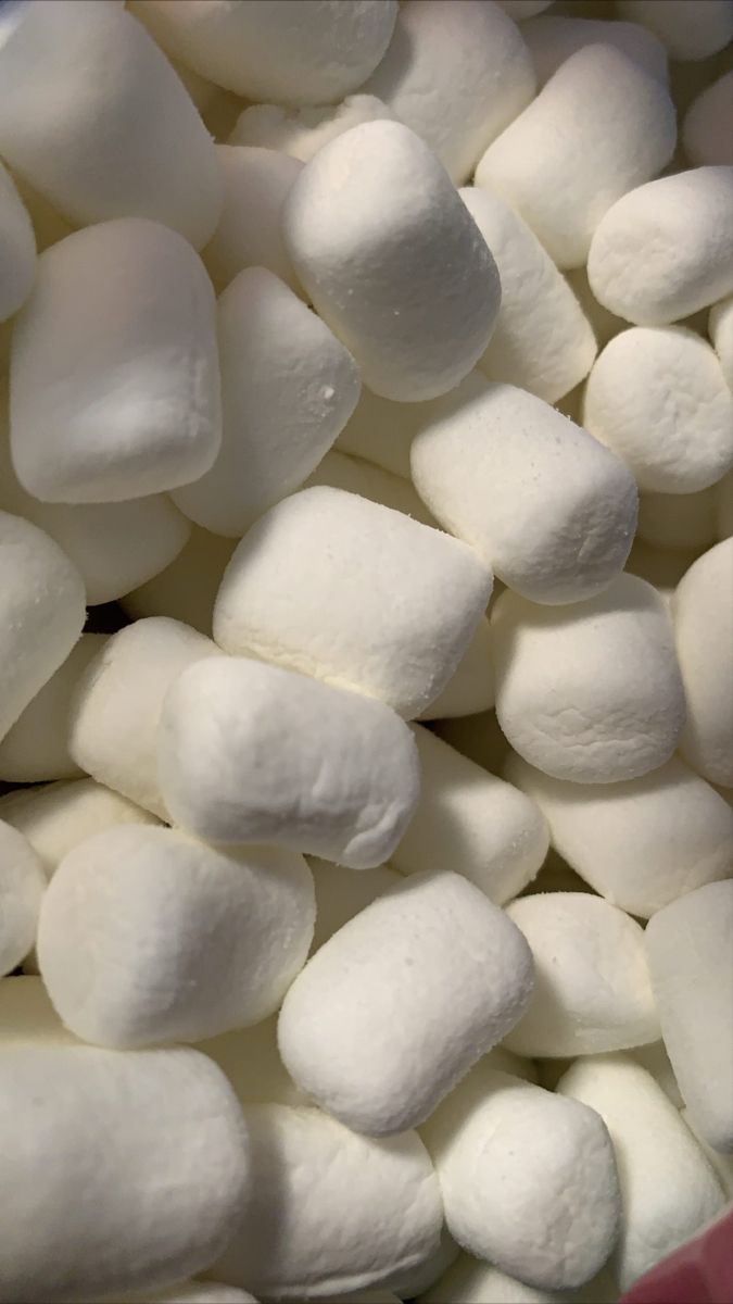 white marshmallows are in a bowl on the table