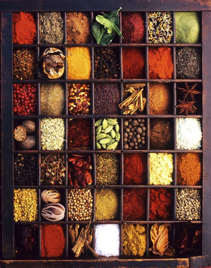 an old wooden box filled with different types of spices