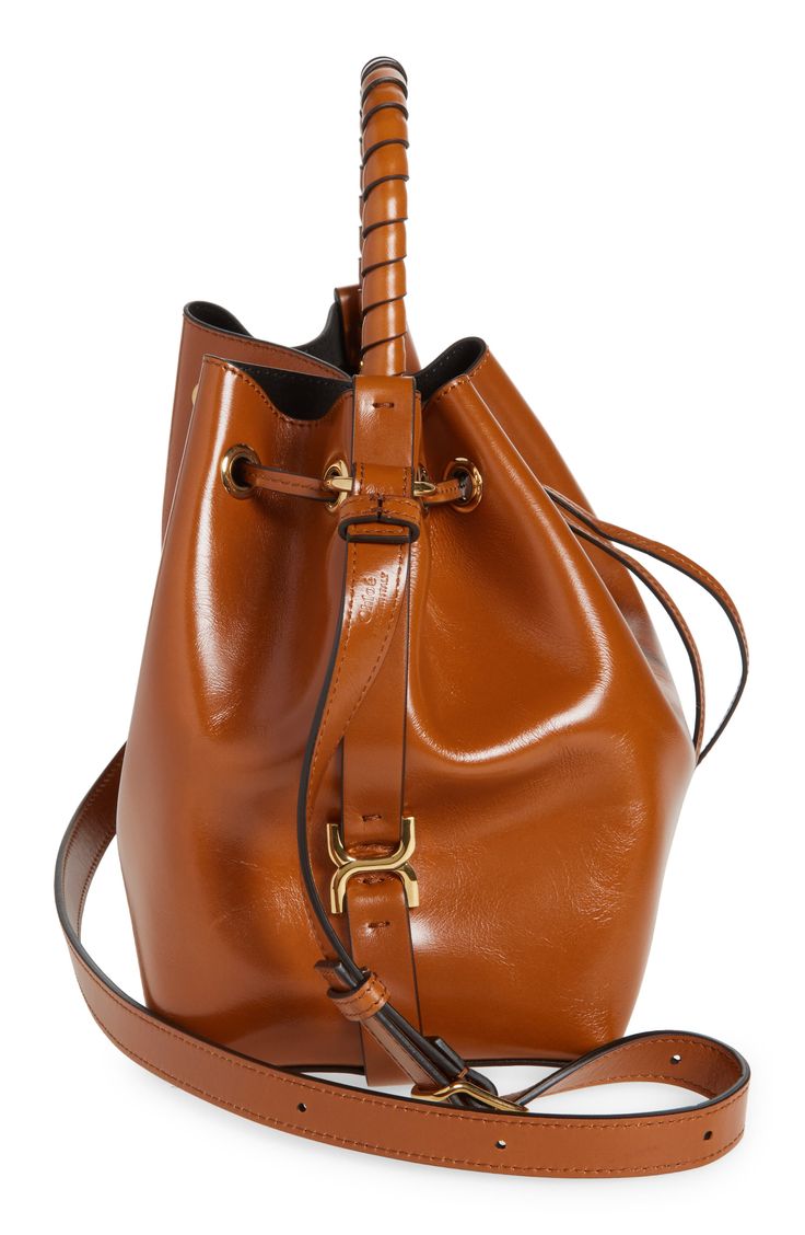 Signature whipstitching and stirrup-inspired hardware reflect the label's equestrian appeal on this roomy bucket bag made of richly polished calfskin leather. Drawstring closure Top carry handle; adjustable crossbody strap Structured silhouette with flat base for stability Leather Made in Italy Designer Handbags This brand has B Corp certification, representing business practices with emphasis on social and environmental performance, accountability and transparency This brand meets Nordstrom Res Brown Calf Leather Bucket Bag With Gold-tone Hardware, Classic Brown Calf Leather Bucket Bag, Luxury Brown Bucket Bag For Office, Designer Calf Leather Bags With Brass Hardware, Calf Leather Bucket Bag For Office, Brown Calf Leather Bucket Bag, Calf Leather Bucket Bag With Gold-tone Hardware For Workwear, Calf Leather Bucket Bag For Travel, Brown Calf Leather Bucket Bag For Work