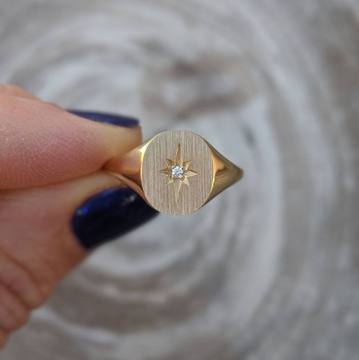 Our solid gold starburst signet ring features a cosmic star set with a sparkling diamond. Choose from 14k, 18k yellow, rose, white gold or platinum. Prefer a colored gemstone in place of the diamond? Just leave us a note at checkout. This ring is a lovely addition to your celestial fine jewelry, and makes a meaningful, timeless (and cool!) gift for your loved ones this holiday season. Details: - Made at our family-run studio in NYC. - Solid 14k, 18k yellow, rose, white gold or platinum -- choose Celestial Style Single Diamond Ring, Star Shaped Signet Ring With Polished Finish, Celestial Diamond Rings Stamped 14k, 14k Gold Celestial Diamond Ring, Classic Star-shaped Jewelry With Single Diamond, Celestial 14k Gold Diamond Ring, Celestial Diamond Jewelry With Single Diamond, Formal Star-shaped Single Diamond Jewelry, Star-shaped Signet Ring With Polished Finish For Anniversary