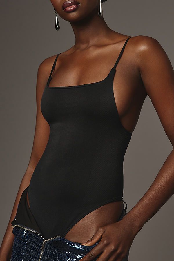 The top-rated Renna is an ultra-soft seamless bodysuit featuring cami straps and a square neckline. | The Renna Seamless Square-Neck Bodysuit by Anthropologie in Black, Women's, Size: Small/Medium, Nylon/Elastane Solid Seamless Bodysuit With Spaghetti Straps, Seamless Solid Color Bodysuit With Spaghetti Straps, High Stretch Spaghetti Strap Bodysuit For Summer, Sleeveless Seamless Sleek Swimwear, Chic Stretch Bodysuit With Straps, Sleek Seamless Sleeveless Swimwear, Backless Bodysuit With Built-in Bra And Minimal Stretch, Sleek Stretch Bodysuit For Beach, Sleek Stretch Bodysuit For The Beach