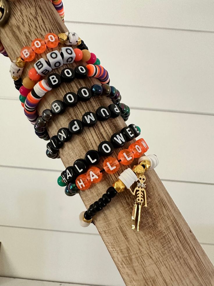 the bracelets are stacked on top of each other in different styles and colors,