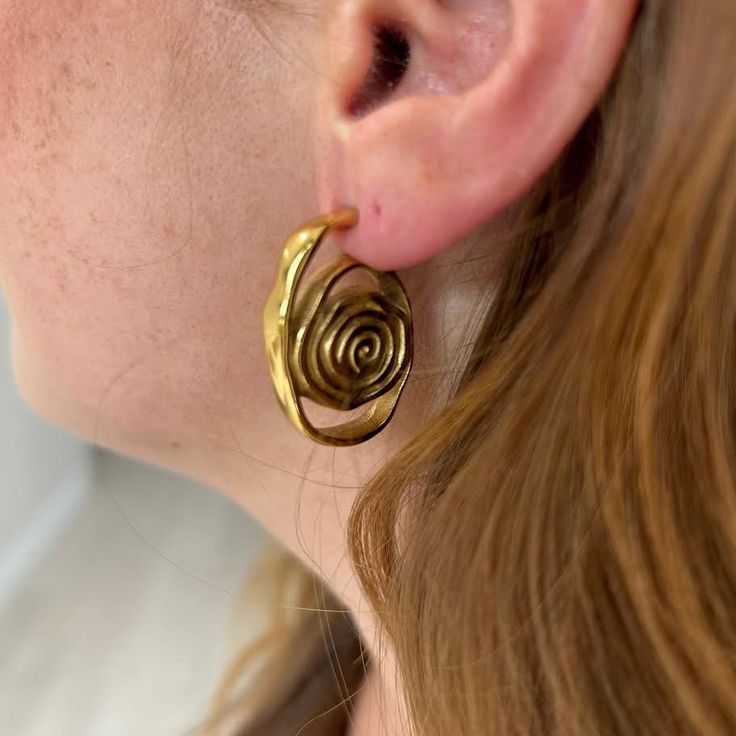 Introducing the Izzy Swirl Earring! Embrace a unique and stylish look with its elegant swirl design. Add a touch of artistry to your outfit and make a statement that will surely turn heads. Elevate your fashion game with these versatile earrings. 18K Gold Plated Over Stainless Steel Hypoallergenic Water & Tarnish Resistant All SALE items are FINAL sale Spiral Gold-plated Earrings, Modern Twist Swirl Earrings For Gifts, Swirl Earrings For Pierced Ears, Swirl-shaped Earrings With Ear Wire, Gold Swirl Earrings For Pierced Ears, Spiral Earrings With A Modern Twist, Gold Spiral Wrap Single Earring, Elegant Swirl Hoop Earrings As Gift, Gold-plated Spiral Earrings For Gift