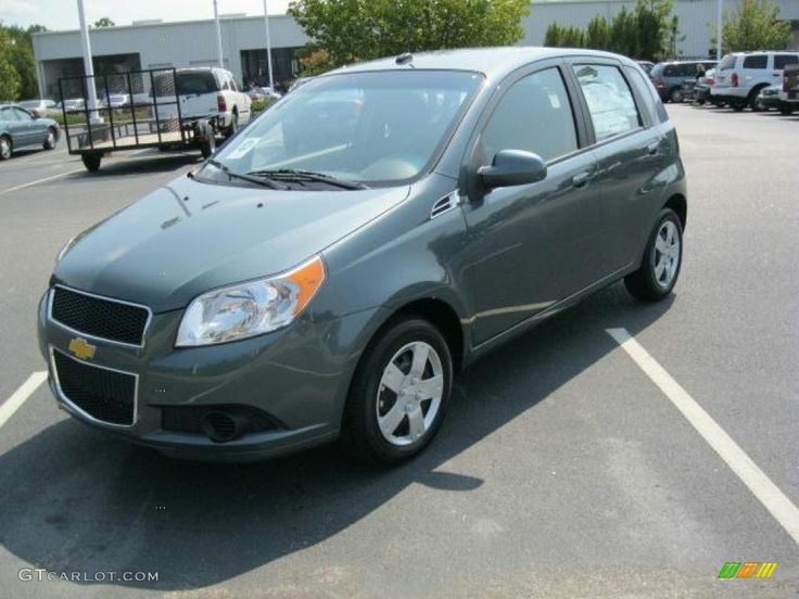 a small gray car parked in a parking lot