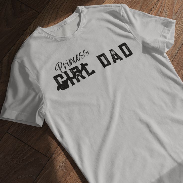 Celebrate Your Father-Daughter Bond with Our 'Girl Dad' T-Shirt – Comfort and Style in One! Show off your pride as a dedicated dad with our 'Girl Dad' unisex soft-style t-shirt. Made from incredibly soft materials, this tee offers a new level of casual comfort, perfect for any occasion. Whether you're attending a family outing, a casual event, or simply enjoying quality time with your daughter, this t-shirt is your go-to choice for both style and comfort. Crafted from 100% ring-spun cotton for solid colors, this lightweight fabric (4.5 oz/yd² or 153 g/m²) ensures a blissfully soft feel all year round. Heather colors and sports grey variants include polyester for added durability. The classic fit, combined with a crew neckline, provides a clean, versatile style suitable for both formal and Father's Day Cotton Slogan T-shirt, Father's Day Cotton T-shirt With Slogan, Father's Day Unisex Crew Neck T-shirt, Unisex Crew Neck T-shirt For Father's Day, Unisex Pre-shrunk T-shirt For Father's Day, Father's Day Relaxed Fit Text Print Tops, Father's Day Text Print Relaxed Fit Tops, Father Daughter Bond, Dad Shirts