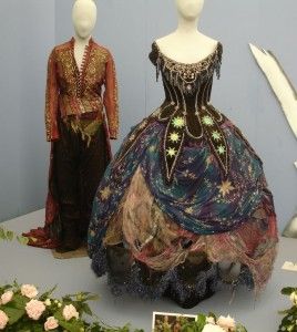 two mannequins dressed in elaborate clothing on display