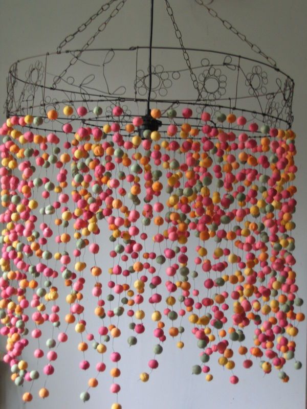 a chandelier with sprinkles hanging from it's sides in a room