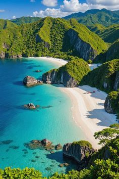 the beach is surrounded by green mountains and clear blue water, with white sand in the foreground