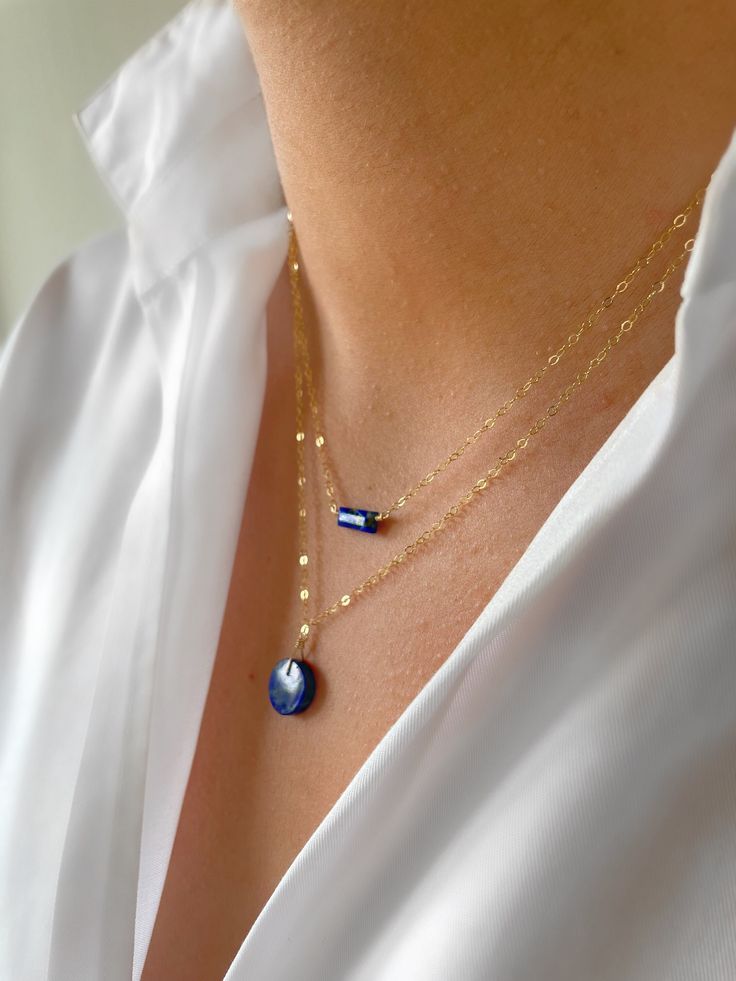 "Vibrant lapis lazuli layering necklaces, the perfect summer vibe. The bar necklace pictured measures 16\" and the coin necklace measures 18\", however I am happy to make custom lengths on request. Both necklaces come in 9ct gold, gold filled, rose gold filled and sterling silver and are beautifully gift wrapped. Lapis lazuli is a highly spiritual stone and is known as the stone of truth and friendship. It brings harmony, love and protection to relationships. It also helps aid awareness and good judgement, which can help deepen relationships Gold filled is made by heat and pressure bonding a layer of karat gold to a metal core. Unlike gold plated, gold filled has an actual layer of karat gold, not just a microscopic film and with the proper care will last a lifetime. I am committed to maki Minimalist 14k Gold Filled Layered Necklace For Gift, Minimalist 14k Gold Filled Layered Necklace As Gift, Dainty Lapis Lazuli Jewelry For Gift, Dainty Lapis Lazuli Jewelry Gift, Dainty Blue Charm Necklace For Everyday, Handmade Lapis Lazuli Jewelry For Everyday, Blue Necklace With Adjustable Chain For Layering, Blue Dainty 14k Gold-filled Jewelry, Dainty Blue 14k Gold-filled Jewelry