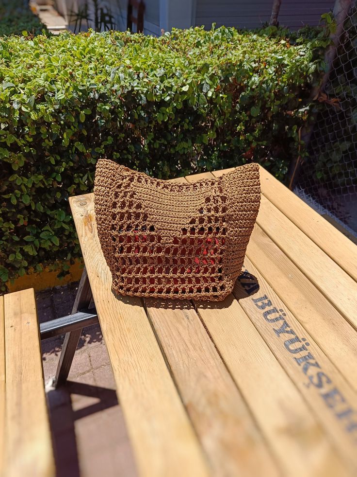 This summer we are introducing a mini version of the brand's viral bag. The bag is medium straw color. Crocheted raffia paper bag for everyday use. An ideal gift for your beloved sister or mother. You can also personalize the lettering on the triangle as you wish. Just write in your order what to write. The embroidery will also be made from black raffia, as in the photo sample. Although it is a mini version, the width of the bag makes it roomy enough to carry everything you need. Size height - 30 cm (11.3 inches) length - 25 cm (9.2 inches) width - 12 cm (4.2 inches) handle - 30 cm (11.3 inches) Brown Jute Bucket Straw Bag, Casual Brown Rectangular Straw Bag, Casual Brown Beach Bag In Natural Fiber, Casual Brown Natural Fiber Bucket Bag, Rectangular Brown Straw Bag For Vacation, Brown Rectangular Straw Bag For Vacation, Casual Handwoven Brown Straw Bag, Brown Casual Jute Straw Bag, Casual Brown Jute Straw Bag