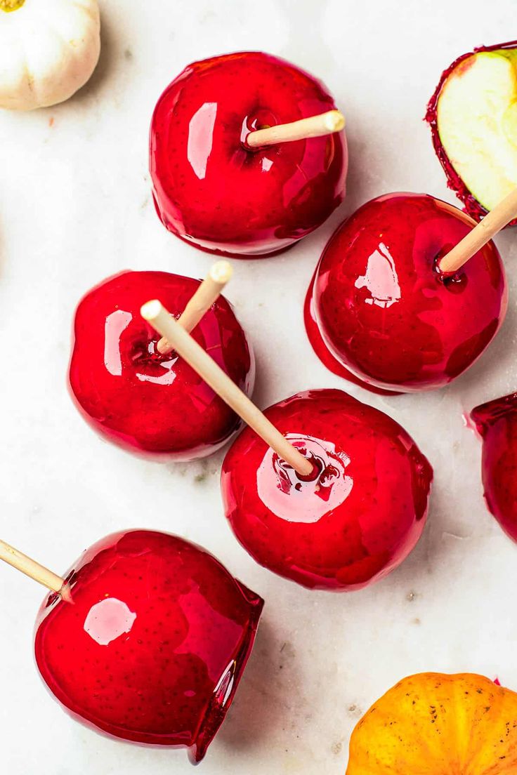 apples with toothpicks in them sitting on a table