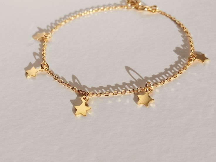 "This star bracelet in gold vermeil(more durable than gold plated) or rhodium silver has 5 handmade little, smooth, and tiny dangling stars. This celestial bracelet is the dainty, boho, and delicate charm bracelet that you need in your jewelry collection! Imagine wearing this silver charm bracelet every day and with all your outfits... You will be amazing! Or, imagine it as your bridesmaid gift to ask them \"would you be my bridesmaid\"... They will love it! I can write them a special note from Gold Bracelet With Star Charm, Adjustable Celestial Bracelets With Star Charm, Gold Bracelet Jewelry With Star Charm, 14k Gold-filled Star Charm Jewelry, Adjustable Gold Chain Bracelet With Star Charm, Celestial Charm Bracelet With Star Charm As Gift, Celestial Star Charm Bracelet Gift, Adjustable Gold Celestial Charm Bracelet, Dainty Adjustable Chain Bracelet With Star Charm