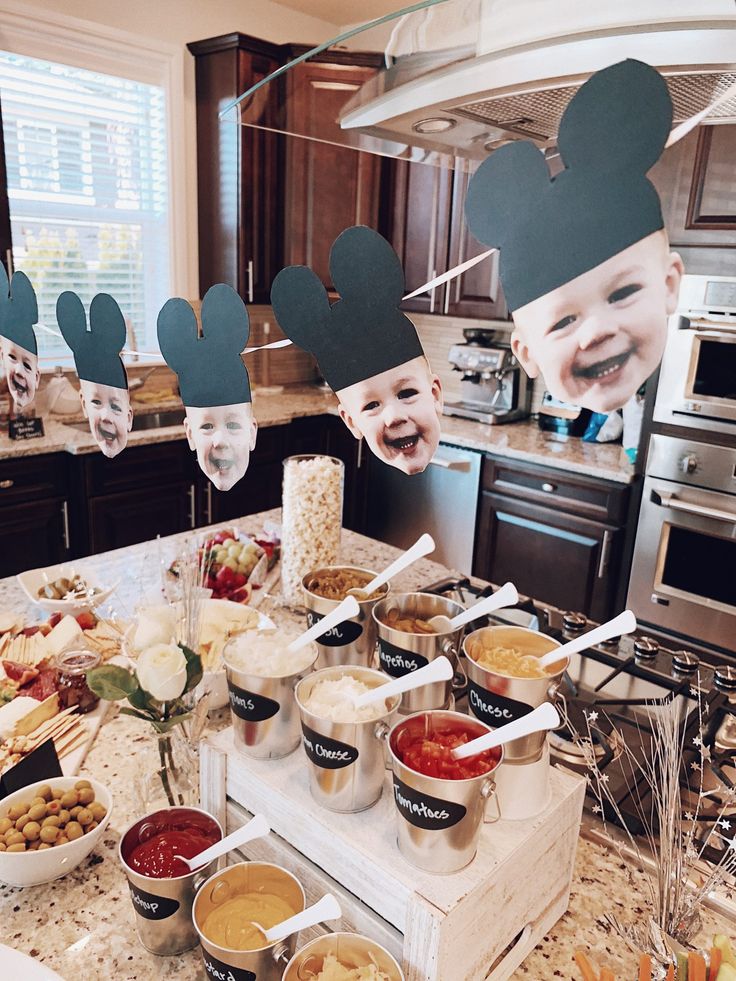 a kitchen counter topped with lots of food and face masks on top of the counter