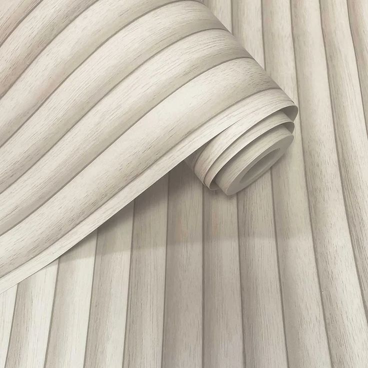 a close up view of a white wood wallpaper with wavy lines on the surface