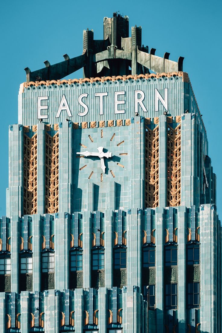 a large clock on the side of a building that says eastern in front of it