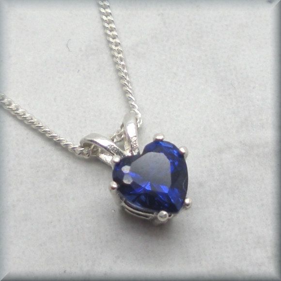 A deep blue lab created sapphire has been set into a sterling silver setting with an open back. Simplicity and so pretty! Perfect for anyone who loves that gorgeous sapphire blue color or anyone with a September birthday (sapphire is the birthstone for those born in September). The heart is a 6mm lab created sapphire gemstone. Both the curb chain and setting are sterling silver. Stones created in a lab are chemically, physically and optically identical to those mined underground. However, they h Heart Shaped Sapphire Jewelry Gift, Heart Shaped Sapphire Jewelry For Gifts, Heart-shaped Sapphire Jewelry Gift, Heart Cut Sapphire Jewelry Gift, Heart Cut Sapphire Necklace Gift, Heart Cut Sapphire Necklace As Gift, Heart Cut Sapphire Jewelry For Gifts, Heart-shaped Sapphire Necklace For Gift, Valentine's Day Sapphire Birthstone Jewelry