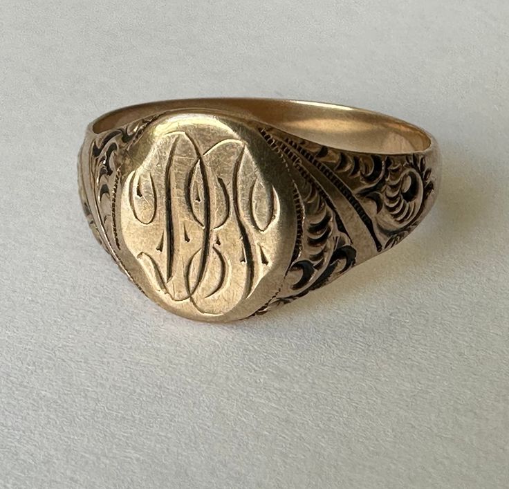 a wonderful antique ring, an oval signet ring with scrollwork details and the initials DT.  this is a Victorian piece, marked 10k and in nice condition.  the carving and engraving were beautifully done.  there is wear on the inner band, some on the face, but a strong lovely piece. size:  7.25 height of face:  10mm width of inner band:  3mm weight:  3.1g Oval Antique Signet Ring As Gift, Antique Oval Signet Ring For Gift, 14k Gold Engraved Ring With Initials For Collectors, Collectible Yellow Gold Signet Ring With Initials, Victorian 14k Gold Signet Ring With Initials, Antique Oval Engraved Ring As Gift, Antique Oval Engraved Ring For Gift, Victorian Gold Signet Ring With Initials, Oval Engraved Signet Ring For Collectors