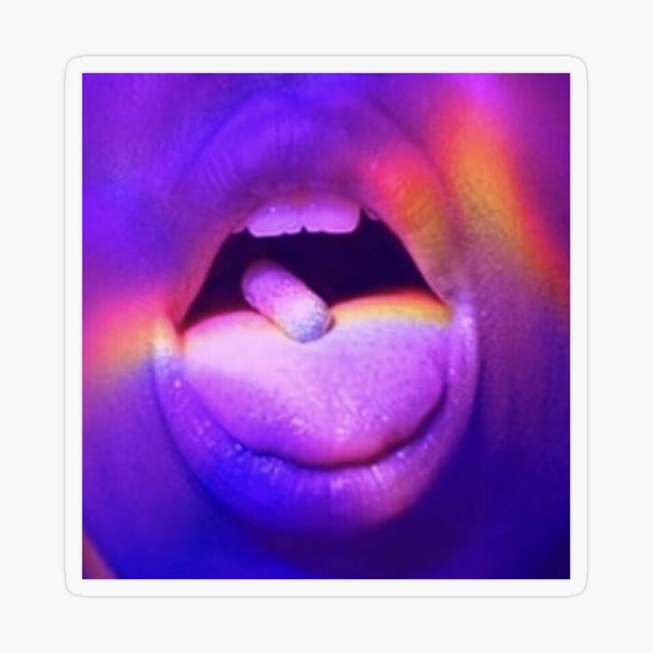 a close up of a person's mouth with a rainbow colored substance on it