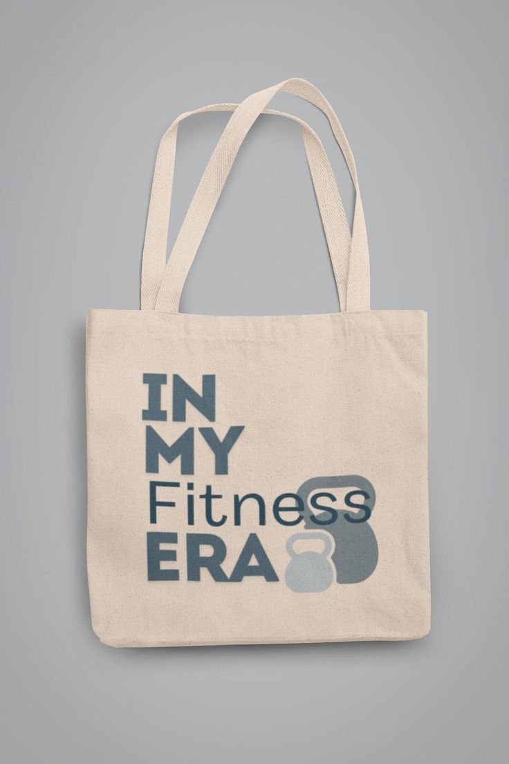 Elevate your workout game with our In My Fitness Era Cotton Canvas Tote Bag! Perfect for fitness enthusiasts and gym-goers, this dynamic tote celebrates your commitment to a healthy and active lifestyle. Key Features: Durable & Spacious: Made from high-quality cotton canvas, this tote is built to last and spacious enough to carry all your fitness essentials, from workout gear to protein shakes. Energetic Design: Featuring a bold and motivational illustration, it's a tribute to those invigorating Athleisure Workout Bags, Sporty Letter Print Bags For Sports, Sporty Letter Print Sports Bag, Sporty Gym Bags With Reinforced Handles, Sporty Gym Tote Bag, Fitness Era, Motivational Illustration, Gym Tote Bag, Fitness Essentials