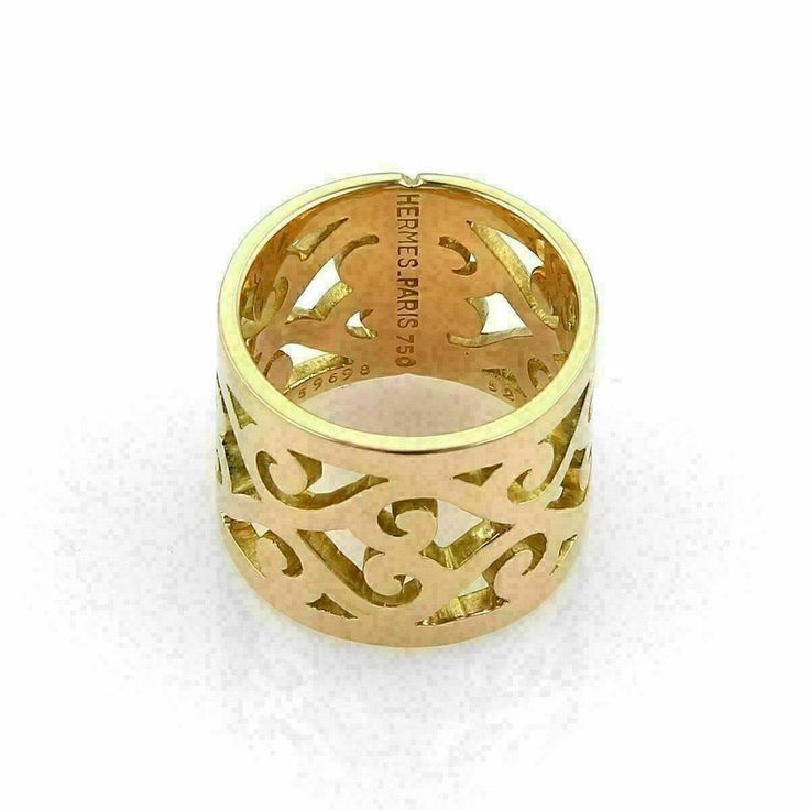 Material: 18k yellow gold Hallmark: Hermes Paris 750 52 59698 Measurements: band is: 15mm wide x 1.5mm high Ring Size: 6 European: 52 Weight: 13.3 grams This lovely authentic band ring is by Hermes and is crafted from solid 18k yellow gold in a high polished finish. The 15mm wide band boast a lovely open swirl scroll design. Great workmanship and design. It is hallmarked with the designer name, metal content, ring size and serial number. 18111-M Elegant Yellow Gold Wide Band Ring With Decorative Band, Luxury Gold Jewelry With Decorative Band, Luxury Wide Band Yellow Gold Ring, Luxury Wide Band Jewelry With Decorative Band, Luxury Gold Wide Band Ring, Luxury Wide Band Gold Jewelry, Luxury Engraved Wide Band Jewelry, Luxury Yellow Gold Wide Band Ring Gift, Luxury Yellow Gold Wide Band Ring For Formal Occasions