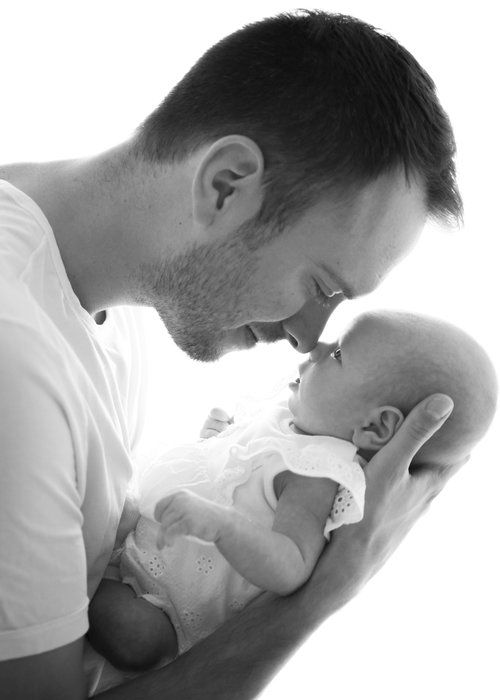 a man holding a baby in his arms