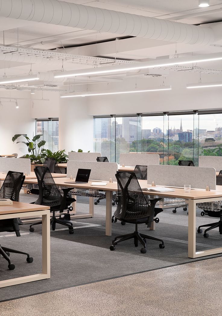 an empty office with desks and chairs