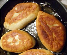 four breads cooking in a skillet on top of a stove burner with oil