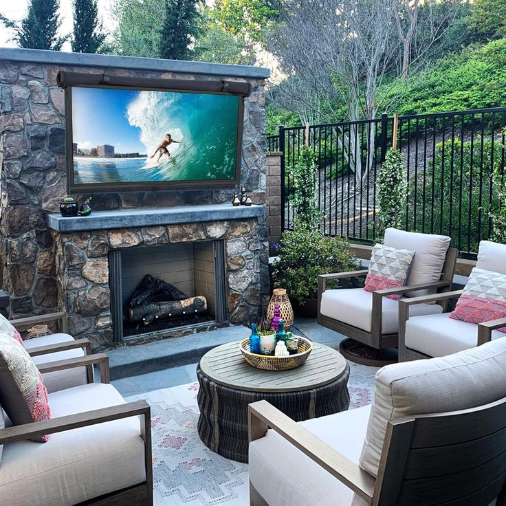 a living room filled with furniture and a flat screen tv mounted to the side of a wall