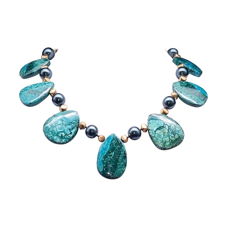 Introducing our captivating creation: the Dramatic and Bold Chrysocolla Oval Plates Necklace, a true one-of-a-kind masterpiece. Crafted with meticulously polished Chrysocolla plates, each exuding its unique allure, this necklace is a celebration of natural elegance. Enhanced with lustrous green freshwater pearls and accented with the richness of vermeil, every element in this piece speaks of luxury and sophistication. Fastened securely with a clasp fashioned from vermeil and Chrysocolla, this necklace drapes gracefully at approximately 17 inches, adorning your neckline with timeless charm. Meticulously hand-knotted with silk, every detail of this necklace speaks to its artisanal craftsmanship and attention to detail. Elevate your style with the unmatched drama and boldness of the Chrysocol Luxury Unique Chrysocolla Necklace, Oval Plates, Plate Necklace, Freshwater Pearls, Hand Knotted, Beaded Necklace, Jewelry Necklaces, Necklaces, Silk