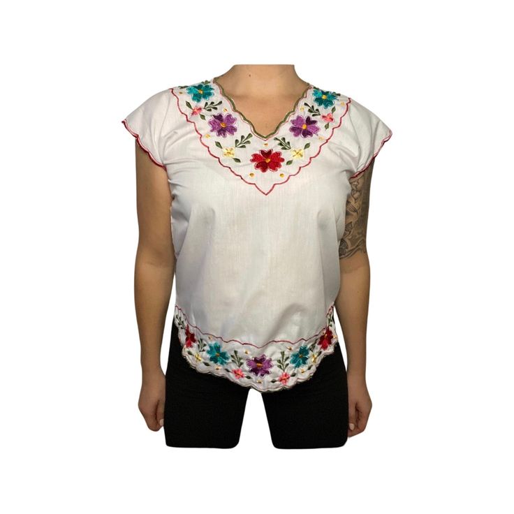 ITEM: vintage hand embroidered top, very delicate and sweet, this is a one of a kind flower child top that will never go out of style. fits like a modern day women's small. model in photo normally wears medium.  TAG READS:  n/a hand made.  MEASUREMENTS 🧵 ✂️ (Taken in inches lying flat are approximately) LENGTH:  24 inches  Measure from top to bottom.  CHEST: 18 inches ( 36 around ) Measure from arm pit to arm pit. We are happy to help you determine if the garment is likely to fit, but cannot of Multicolor Floral Embroidered V-neck Top, Vintage White V-neck Top, Traditional V-neck Blouse With Embroidered Hem, Multicolor Embroidered Cotton V-neck Top, White Bohemian Tops With Floral Embroidery, White Casual Tops With Boho Collar, White Casual Top With Boho Collar, Fitted Floral Embroidered Top For Festival, Spring Folk V-neck Tops